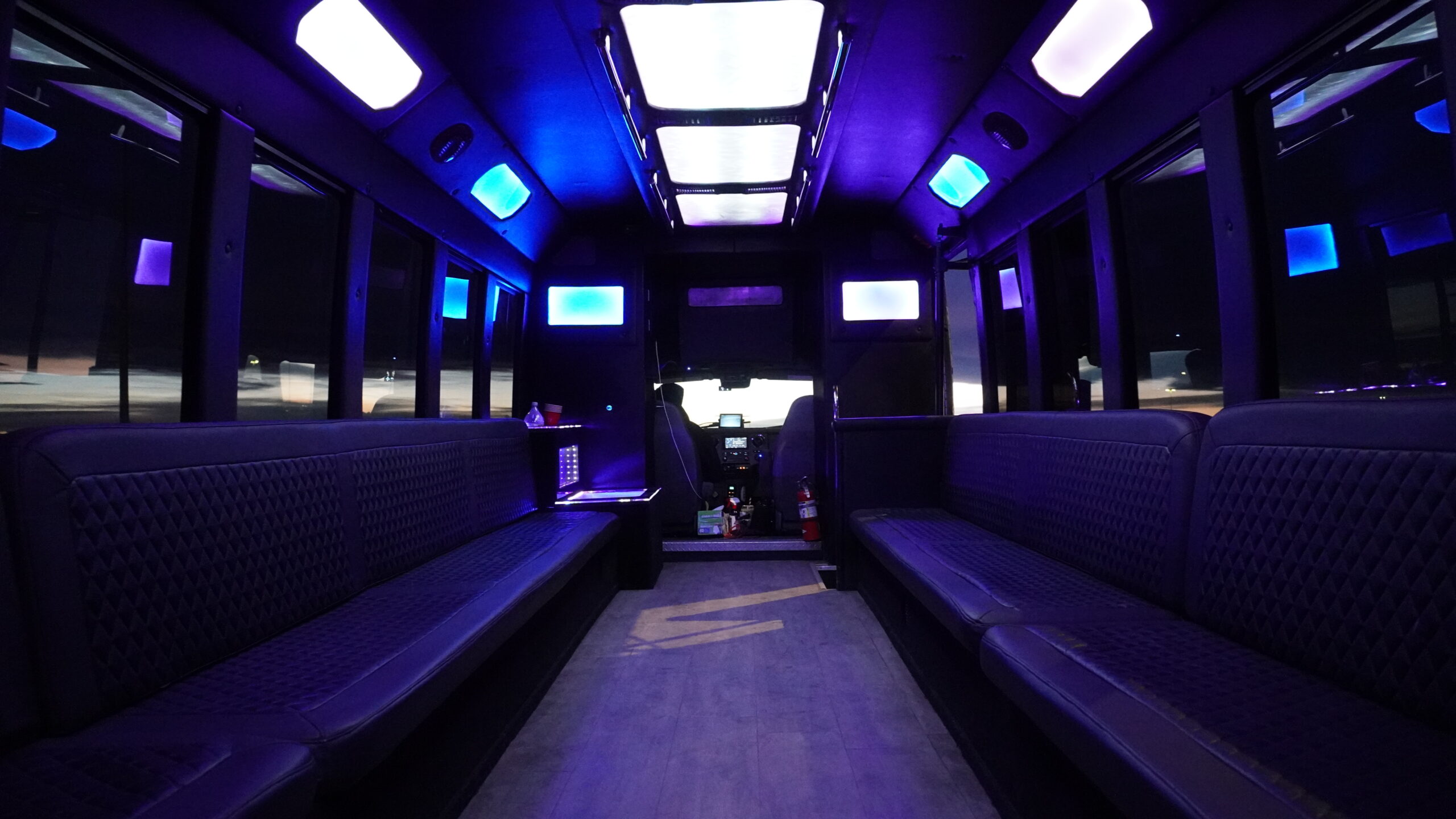 Mastering the First Impression: Your intriguing post title goes here Luxury interior of a Calgary party bus with LED lighting and premium seating